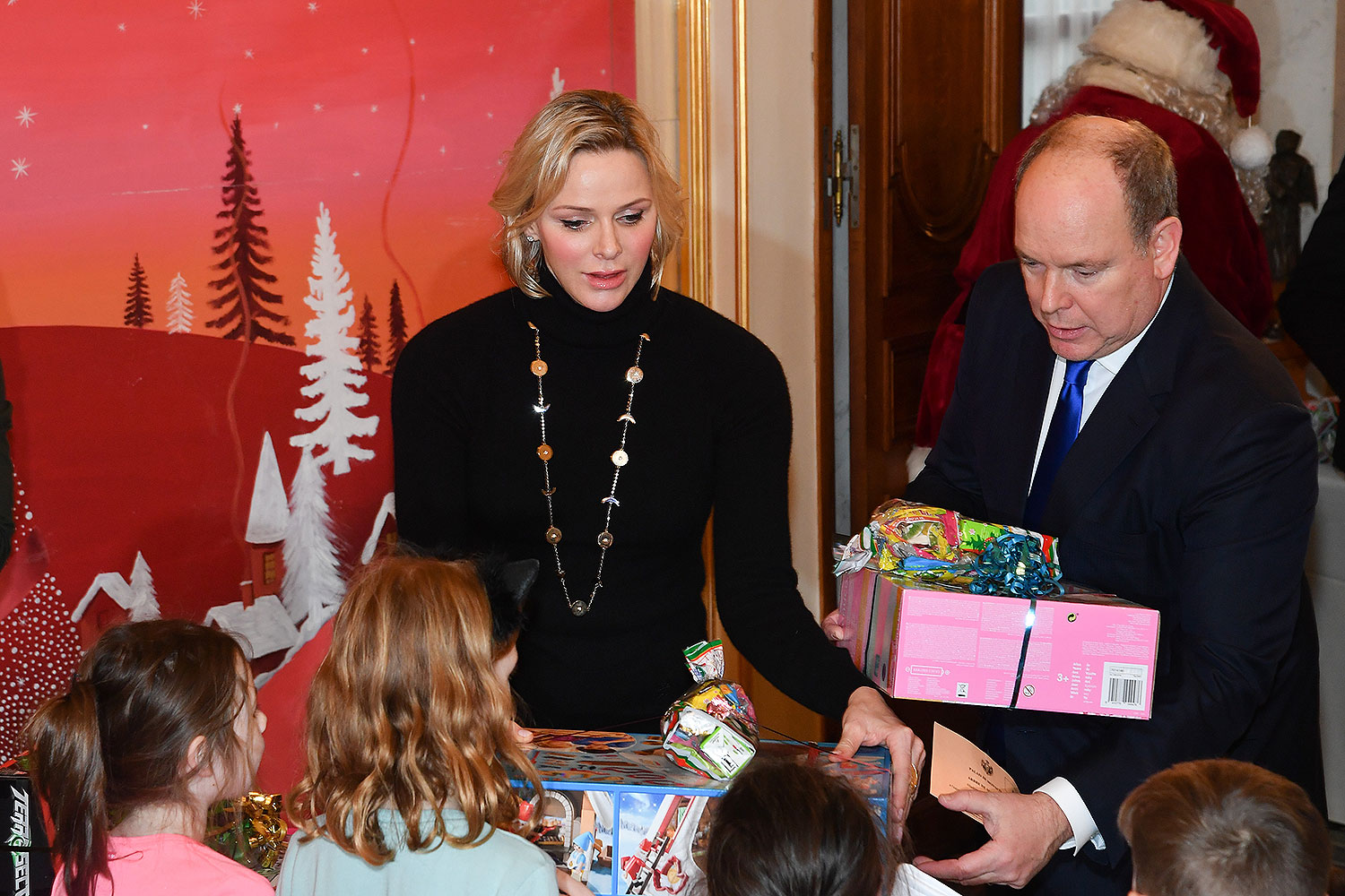 Princess Charlene of Monaco and Prince Albert II of Monaco attend the Christmas Gifts Distribution At the Palace